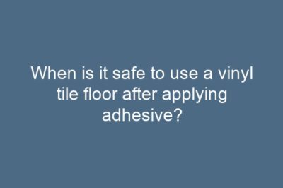 When is it safe to use a vinyl tile floor after applying adhesive?